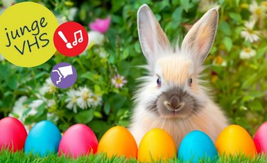 Osterhase im Gras mit Ostereiern